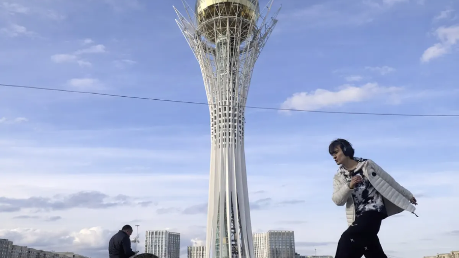 Russian Man Dances at Baiterek Monument After Fleeing Draft